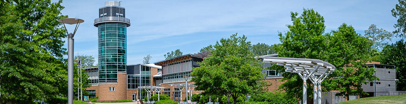 The Tom Ridge Environmental Center surrounded by green trees on a sunny day