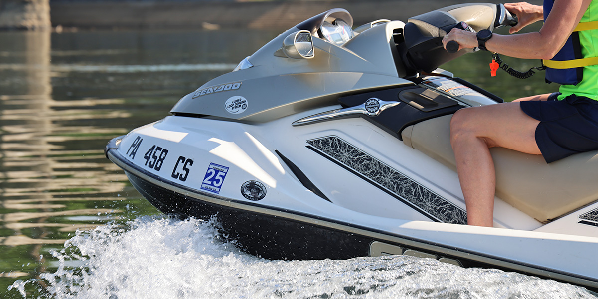 Close-up of a person wearing a life jacket operating a jet ski (or personal watercraft) on the Susquehanna River