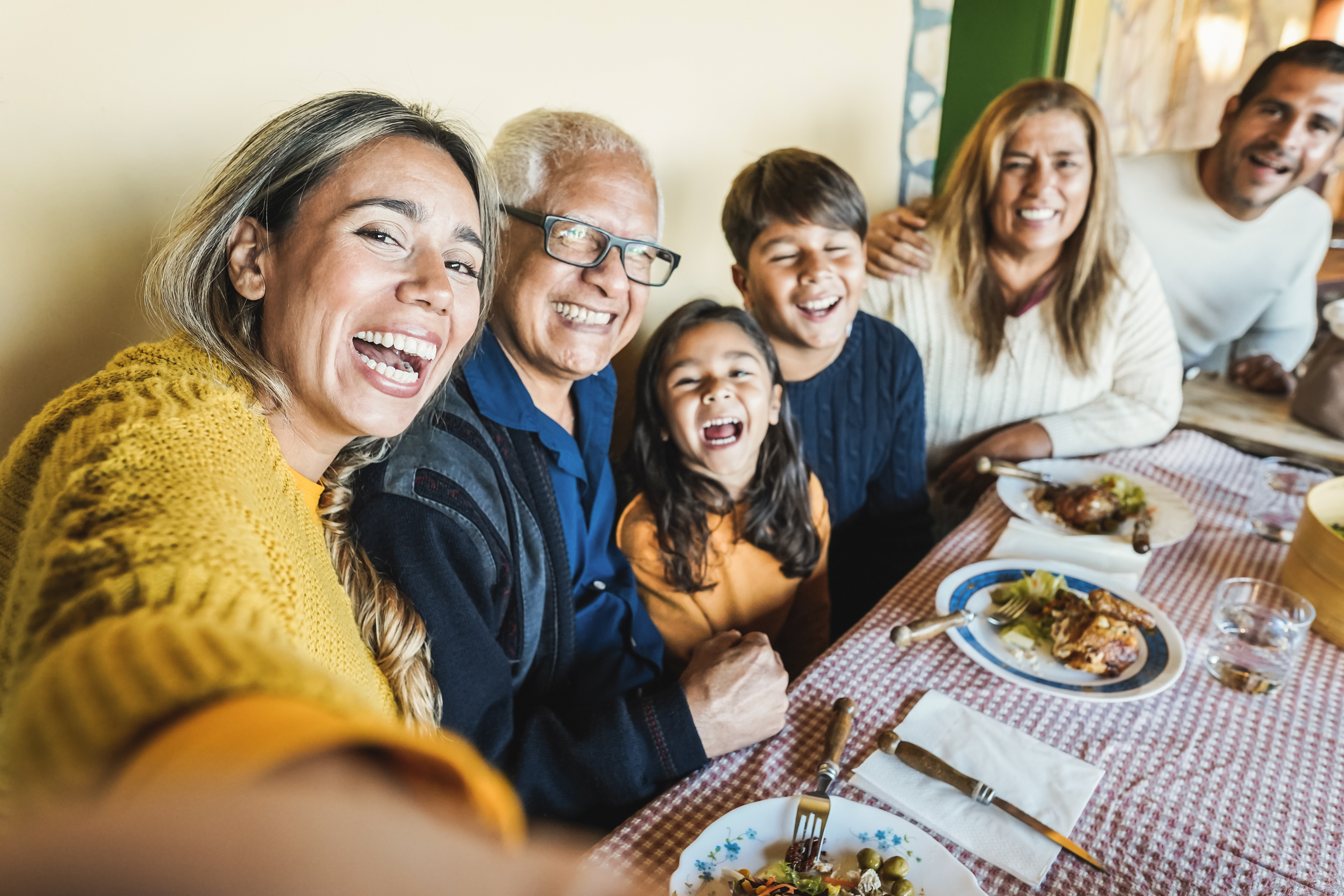 Happy latin family doing selfie while <a href=