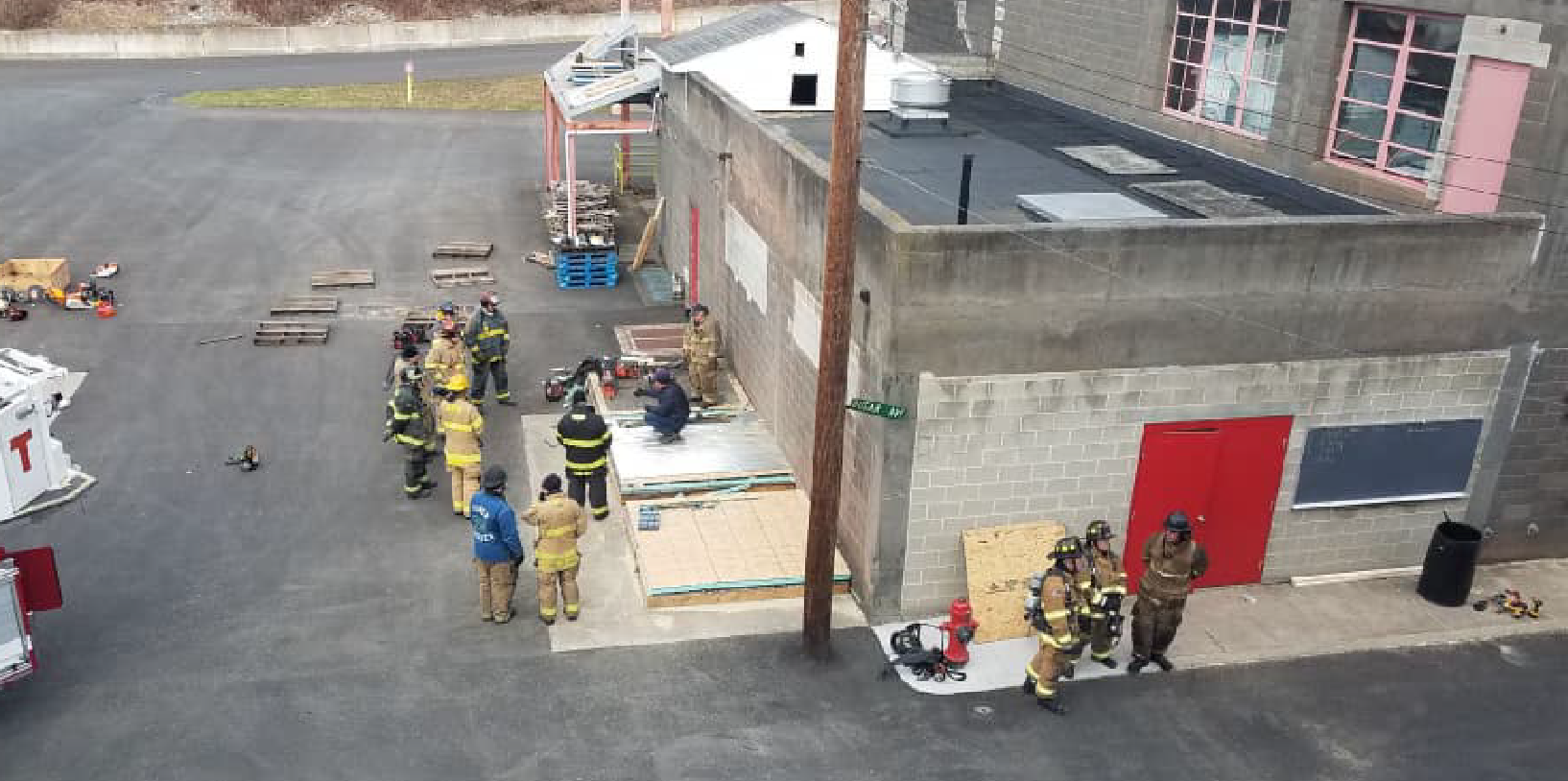 Firefighters complete a training at a building on Fire Academy grounds.