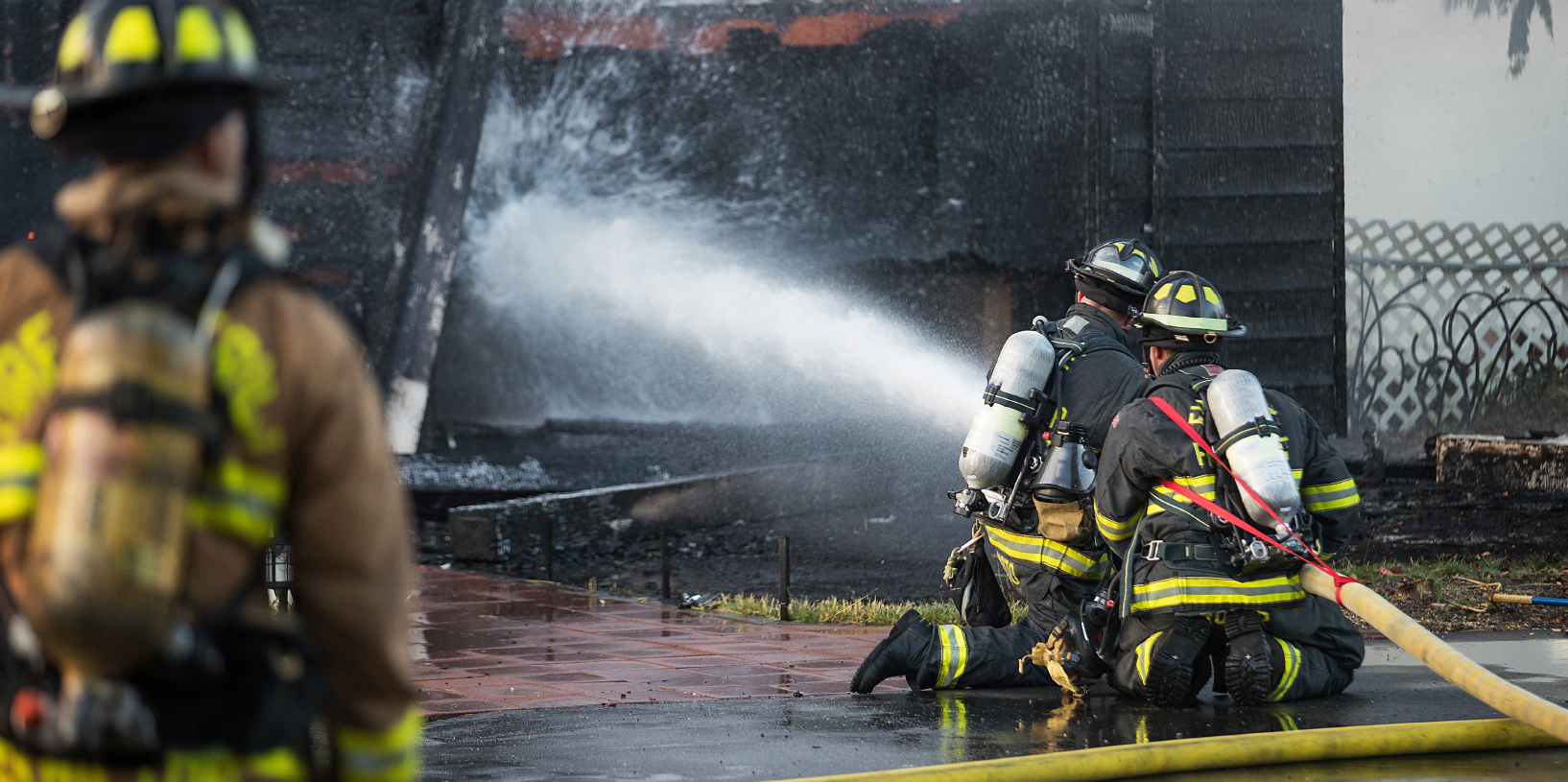 Firefighters suppress a blaze from the exterior.