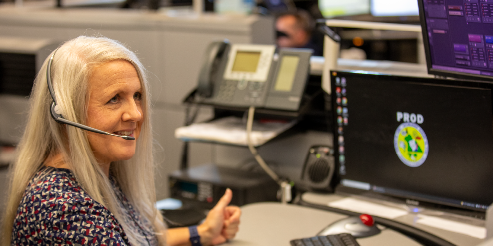 A 911 dispatcher takes a call inside a 911 center.