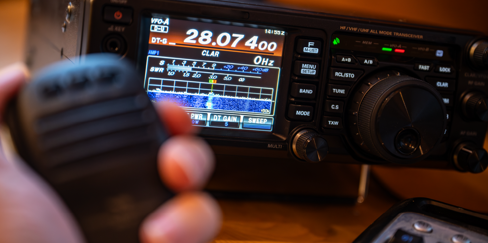 Hand holding an emergency radio.