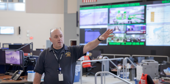 A PEMA employee gestures inside the response center.