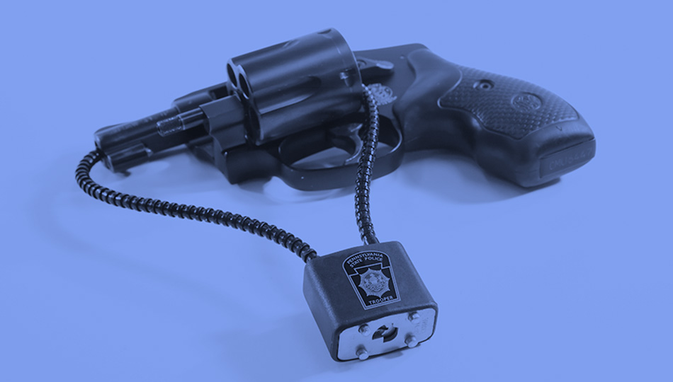 a revolver with a gun lock inserted through the cylinder