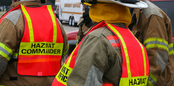 Hazmat team in orange vests.