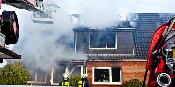 Firefighters battle a house fire.