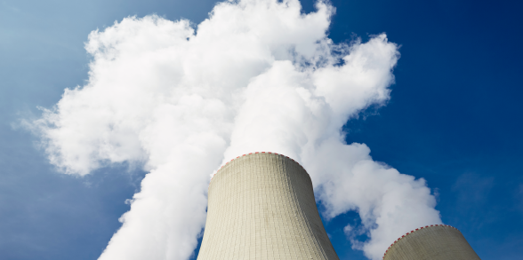 Plumes rise up from a nuclear power plant.